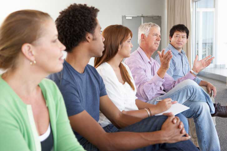 photo of people sitting and talking at AA-meeting group meeting