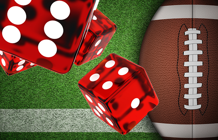 photo of dice superimposed over a football to symbolize gambling