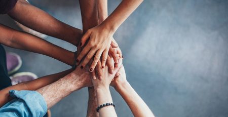 group of people holding hands together