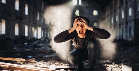 woman in an abandoned building screaming