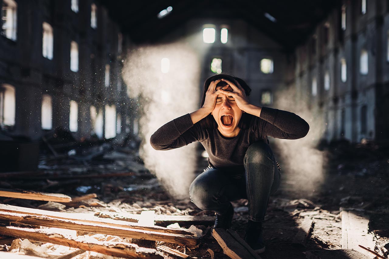 woman in an abandoned building screaming