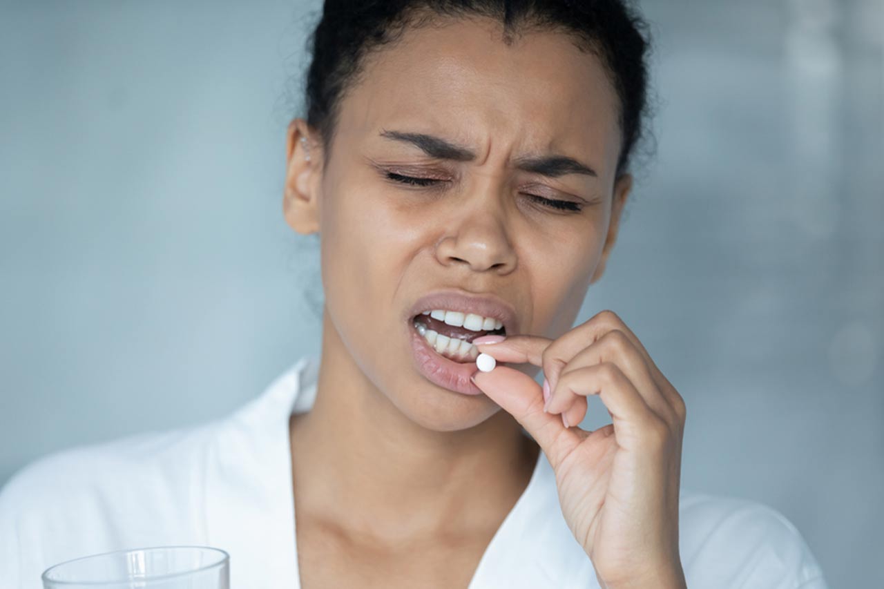 woman taking pills