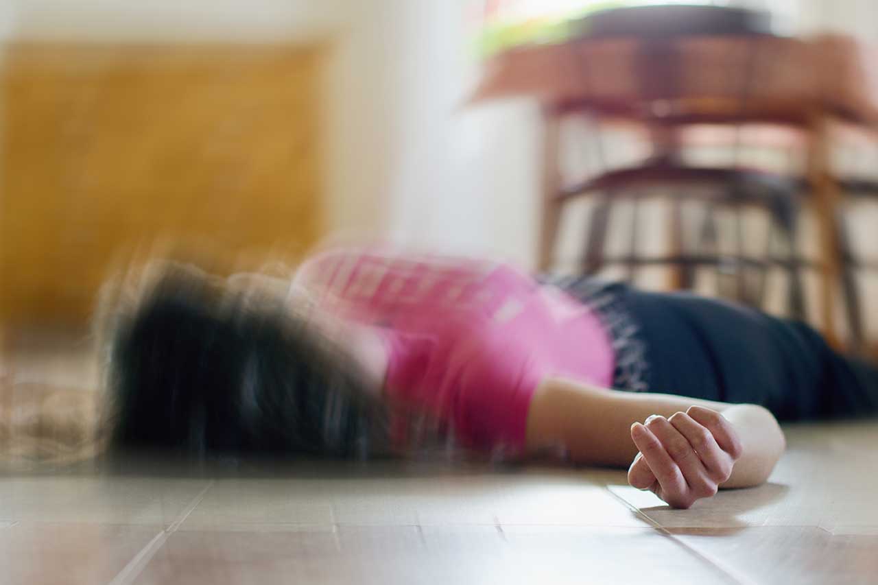 person lying on the dining floor