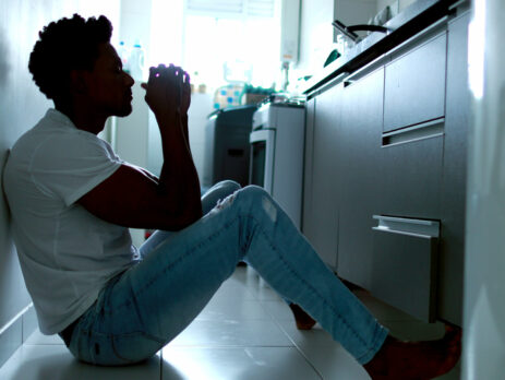 Man sitting in front of kitchen drawer