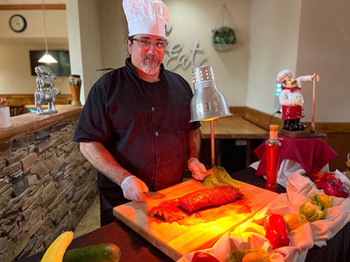 Facility chef preparing a fresh meal for clients