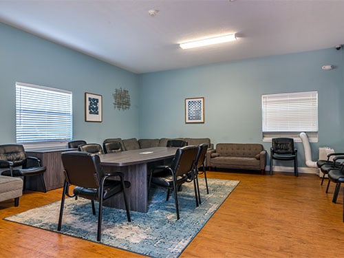 group therapy and meeting room with chairs arranged around a large table