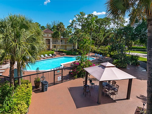 Outdoor swimming pool and landscaped recreation area at the treatment center
