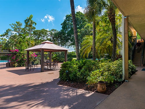 Landscaped courtyard with a shaded gazebo and outdoor seating