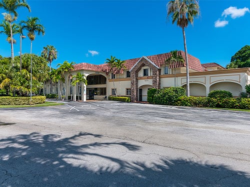 Palm-lined entrance to the behavioral health treatment center in South Florida