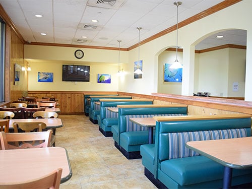 Bright dining room with booths and tables at the treatment center